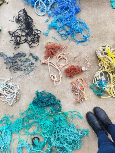 Blue, green, yellow, orange, white and black materials Puppet Kit, Ghost Net -  artwork by Emily Miller